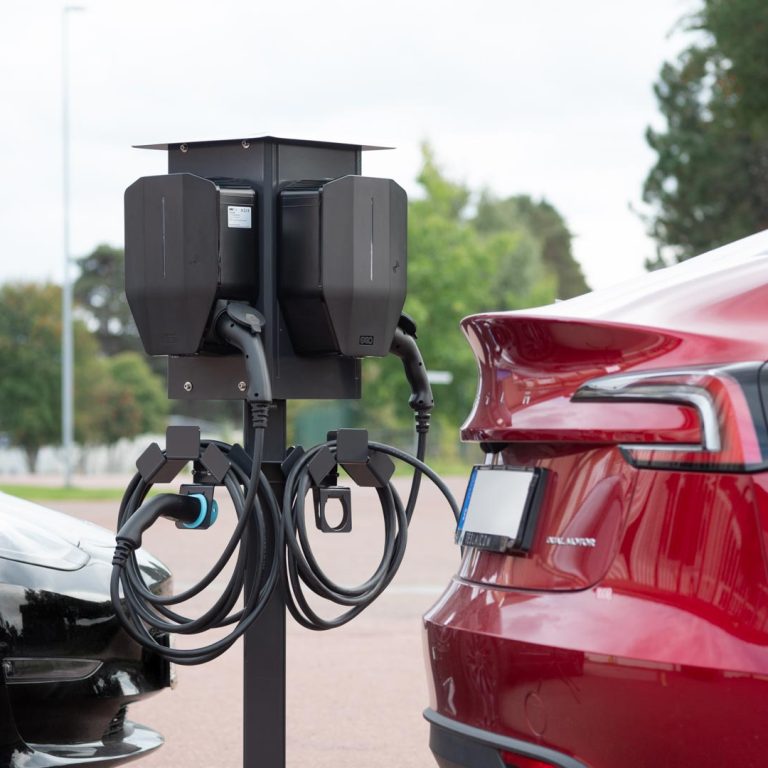 Next Green Polebox 270 Q Laddboxhållare för fyra laddboxar på Piedestal Dynamic eller Ø 60 mm stolprör. Här med laddkabelhålare Next Green Daytona T2 för typ 2 CCS kablar med Next Green Piedestal Dynamic med dubbel FL13 fläns samt Klammersats 80x80 quattro